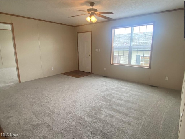 67330 Ebbert Rd Unit 9, Saint Clairsville, OH 43950 - empty room with carpet, ornamental molding, and a ceiling fan