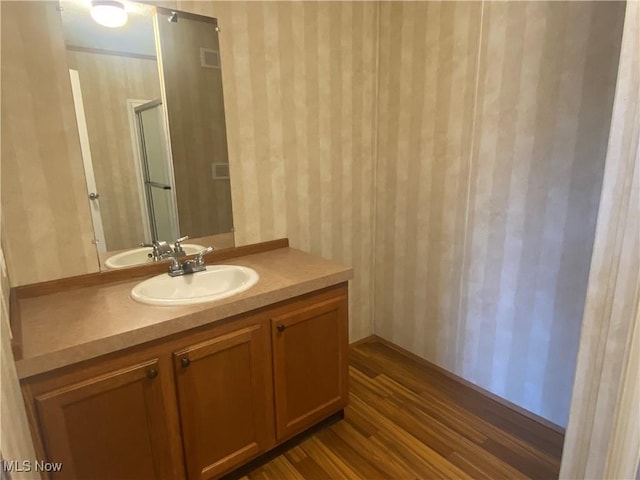 67330 Ebbert Rd Unit 9, Saint Clairsville, OH 43950 - bathroom featuring wallpapered walls, vanity, wood finished floors, and a shower with door
