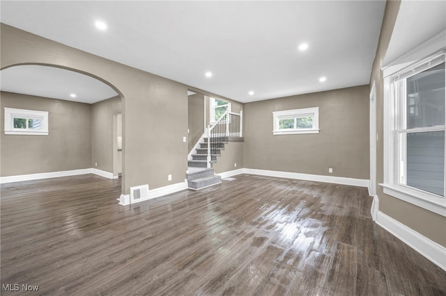 12616 Arlington Ave, Cleveland, OH 44108 - unfurnished room with arched walkways, wood finished floors, stairway, and recessed lighting
