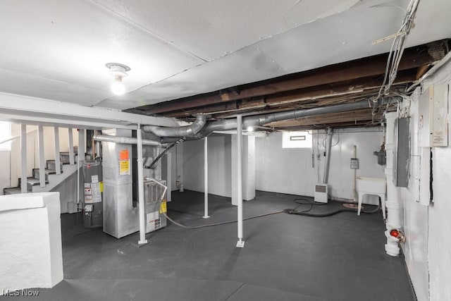 2830 Harmont Ave NE, Canton, OH 44705 - basement featuring water heater, heating unit, stairway, and electric panel