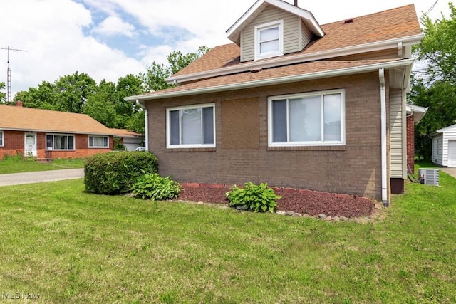 2830 Harmont Ave NE, Canton, OH 44705 - view of side of property featuring brick siding, a yard, and a shingled roof