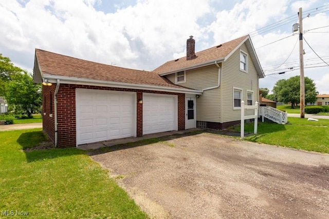 2830 Harmont Ave NE, Canton, OH 44705 - view of home's exterior with brick siding, a chimney, a garage, a yard, and roof with shingles
