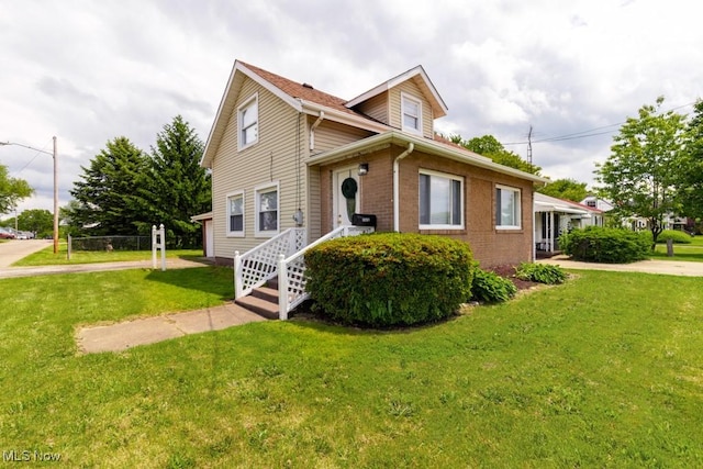 2830 Harmont Ave NE, Canton, OH 44705 - traditional-style house with a front yard and brick siding