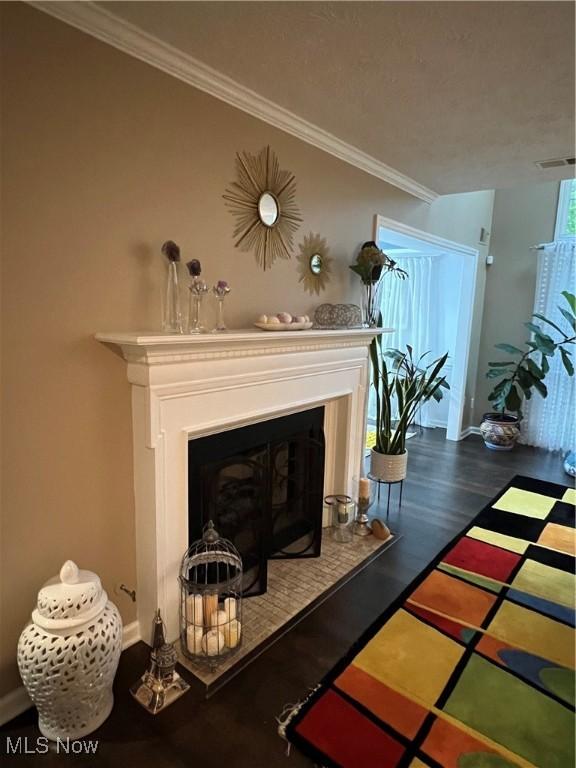 4389 Devonshire Dr, Boardman, OH 44512 - detailed view of crown molding, a fireplace with raised hearth, and wood finished floors