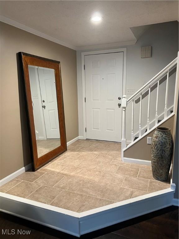 4389 Devonshire Dr, Boardman, OH 44512 - entrance foyer with crown molding, stone finish floors, and stairway