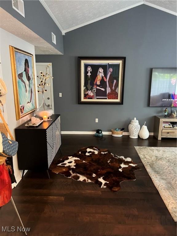 4389 Devonshire Dr, Boardman, OH 44512 - home theater with ornamental molding, lofted ceiling, wood finished floors, and a textured ceiling