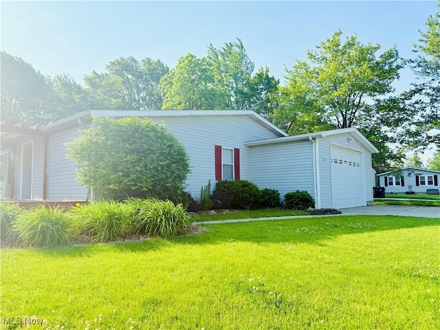 133 Walleye Ct, Lagrange, OH 44050 - view of front facade with a front yard, asphalt driveway, and a garage