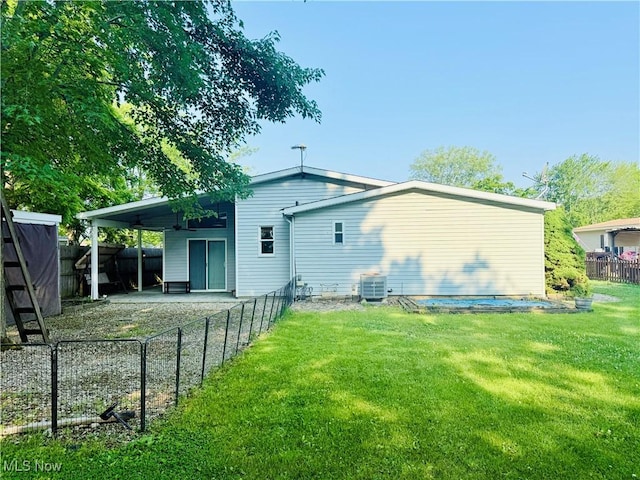 133 Walleye Ct, Lagrange, OH 44050 - back of house with a fenced backyard, a carport, and driveway