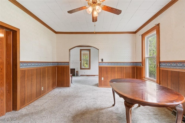 436 N Portage St, Doylestown, OH 44230 - dining room with arched walkways, wainscoting, wood walls, ornamental molding, and a ceiling fan