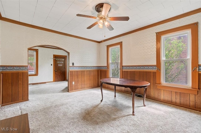 436 N Portage St, Doylestown, OH 44230 - dining room featuring arched walkways, wainscoting, carpet floors, wooden walls, and a ceiling fan