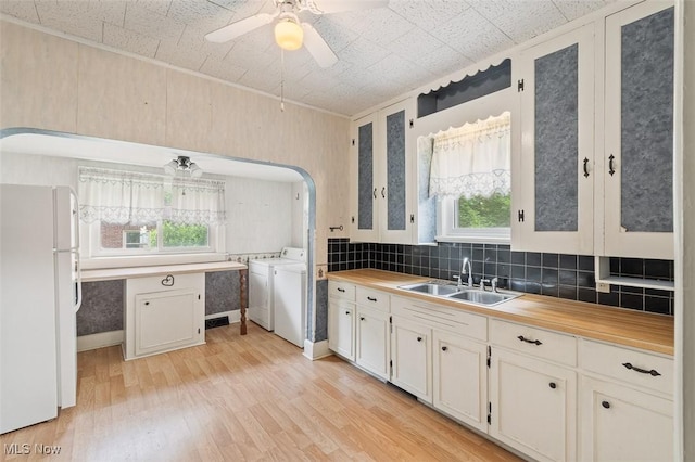 436 N Portage St, Doylestown, OH 44230 - kitchen featuring freestanding refrigerator, separate washer and dryer, healthy amount of natural light, and light wood-style flooring