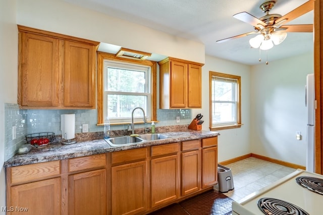 11339 Ridge Rd, North Royalton, OH 44133 - kitchen featuring white appliances, decorative backsplash, brown cabinetry, and ceiling fan