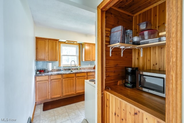 11339 Ridge Rd, North Royalton, OH 44133 - kitchen with stainless steel microwave, stone countertops, wooden walls, and brown cabinets