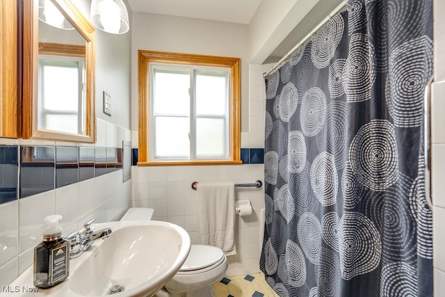11339 Ridge Rd, North Royalton, OH 44133 - bathroom with tile walls, a wainscoted wall, healthy amount of natural light, and a shower with curtain