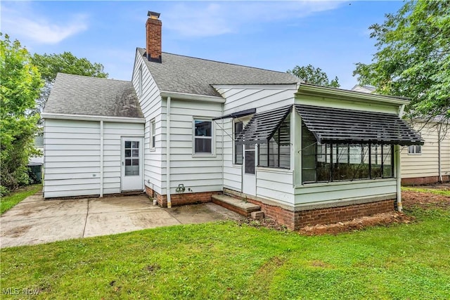 416 E 255th St, Euclid, OH 44132 - rear view of property with a sunroom, a chimney, a yard, and a patio area