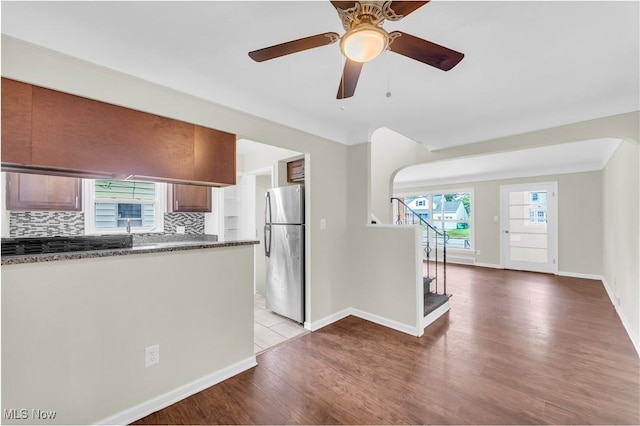 416 E 255th St, Euclid, OH 44132 - kitchen with freestanding refrigerator, backsplash, wood finished floors, and a ceiling fan