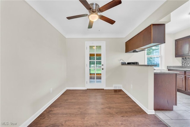416 E 255th St, Euclid, OH 44132 - kitchen featuring light wood-style floors, a ceiling fan, light countertops, and a peninsula