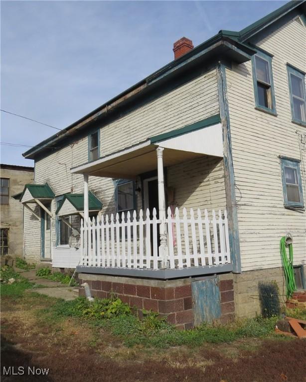 104 Jefferson St, Belmont, OH 43718 - view of side of home with a porch and a chimney