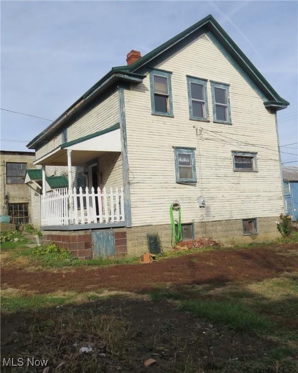 104 Jefferson St, Belmont, OH 43718 - view of home's exterior with a chimney and a porch