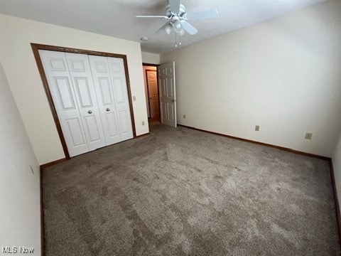 2132 University Commons Dr SE, Massillon, OH 44646 - unfurnished bedroom with carpet, a closet, and a ceiling fan