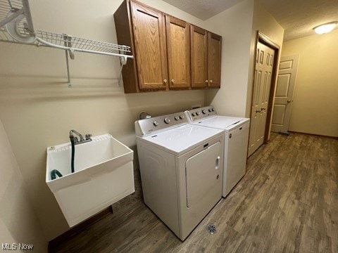 2132 University Commons Dr SE, Massillon, OH 44646 - laundry room with washing machine and clothes dryer, dark wood-style flooring, and cabinet space