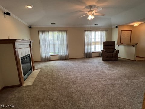 2132 University Commons Dr SE, Massillon, OH 44646 - living room with ornamental molding, a ceiling fan, light colored carpet, and a tile fireplace