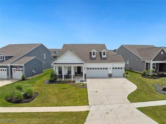 23761 St Andrews Dr, Columbia Station, OH 44028 - view of front of home with covered porch, an attached garage, concrete driveway, a front lawn, and stone siding