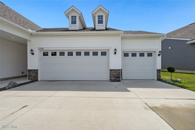 23761 St Andrews Dr, Columbia Station, OH 44028 - view of front of home with stone siding, driveway, and a garage