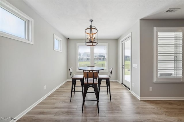 23761 St Andrews Dr, Columbia Station, OH 44028 - dining area with a chandelier, wood finished floors, and a textured ceiling