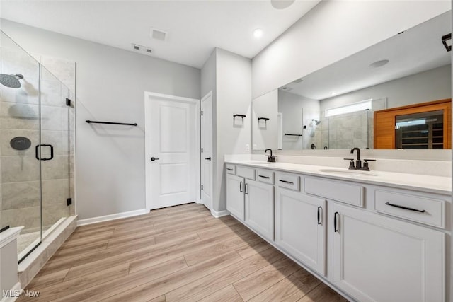 23761 St Andrews Dr, Columbia Station, OH 44028 - bathroom featuring double vanity, a shower stall, and wood finished floors