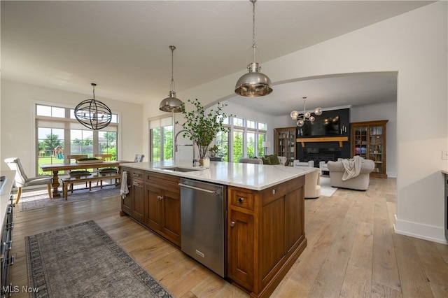 7324 Roman Ave NW, Massillon, OH 44646 - kitchen with dishwasher, a chandelier, light countertops, brown cabinetry, and healthy amount of natural light
