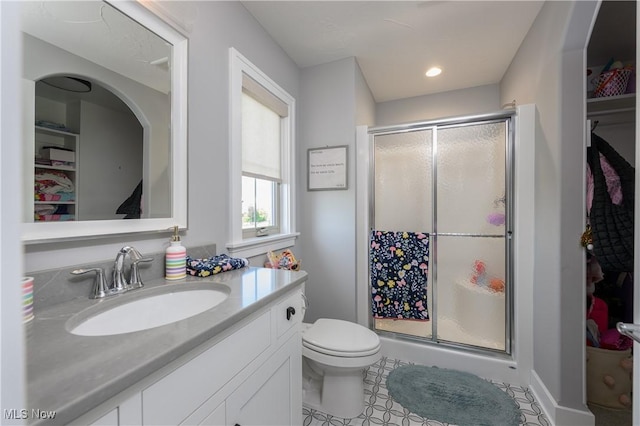 7324 Roman Ave NW, Massillon, OH 44646 - bathroom with a shower stall, a walk in closet, and vanity