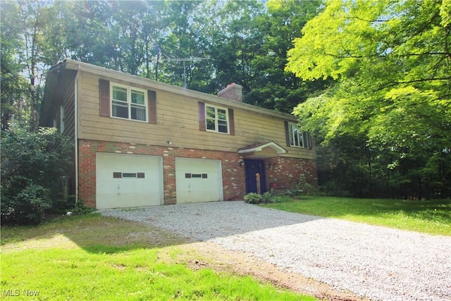 8630 Williams Rd, Chardon, OH 44024 - view of front of property with gravel driveway, brick siding, a chimney, and a garage
