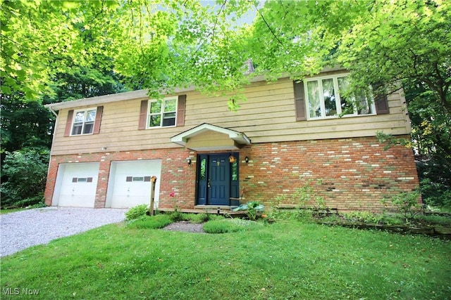 8630 Williams Rd, Chardon, OH 44024 - view of front of house featuring gravel driveway, a garage, brick siding, and a front yard