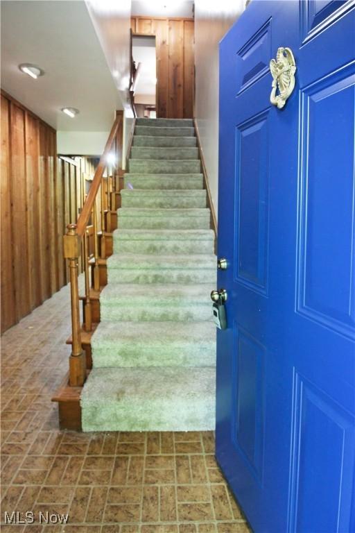 8630 Williams Rd, Chardon, OH 44024 - stairs featuring brick patterned floors and wood walls