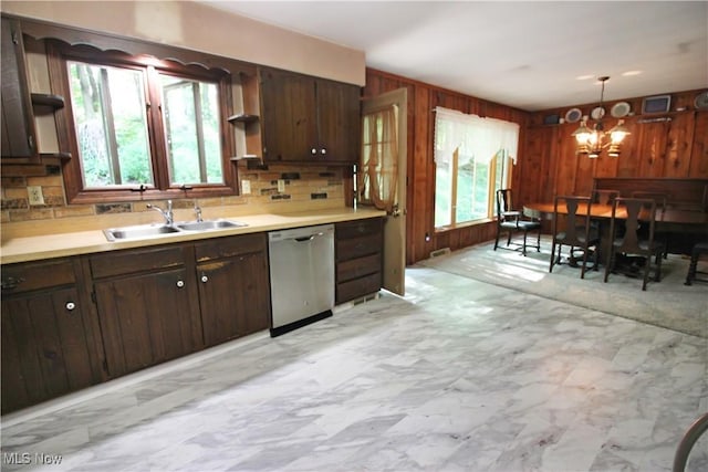 8630 Williams Rd, Chardon, OH 44024 - kitchen featuring stainless steel dishwasher, open shelves, healthy amount of natural light, wooden walls, and decorative backsplash