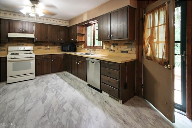 8630 Williams Rd, Chardon, OH 44024 - kitchen featuring white range oven, under cabinet range hood, stainless steel dishwasher, and decorative backsplash