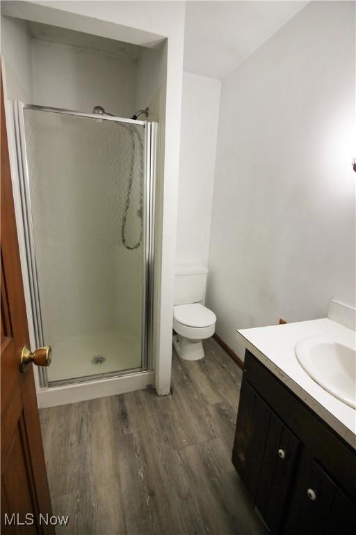 8630 Williams Rd, Chardon, OH 44024 - full bath featuring wood finished floors, vanity, and a stall shower