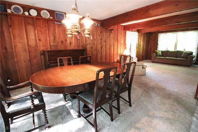 8630 Williams Rd, Chardon, OH 44024 - dining room with a chandelier, wooden walls, and carpet