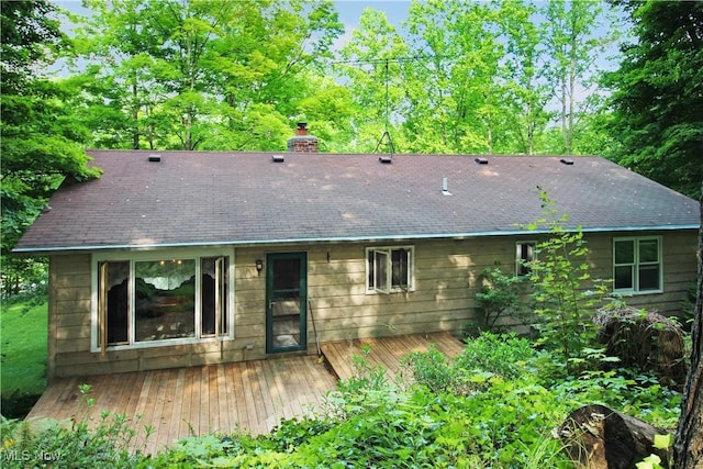 8630 Williams Rd, Chardon, OH 44024 - back of property with a deck, a chimney, and roof with shingles