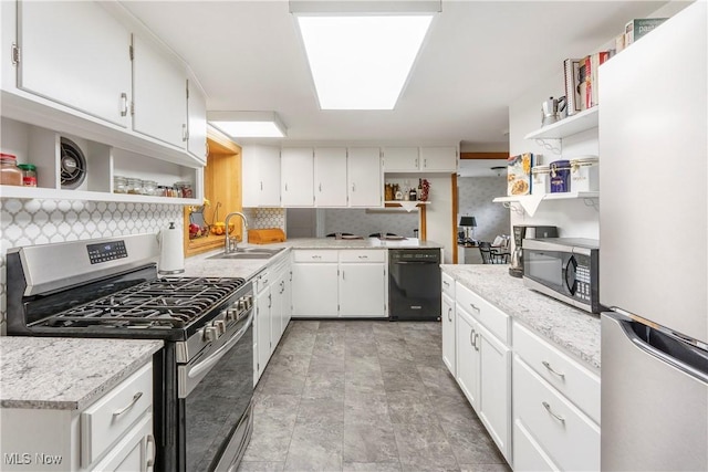 218 Bonnett St SW, North Canton, OH 44720 - kitchen featuring open shelves, stainless steel appliances, decorative backsplash, and white cabinetry