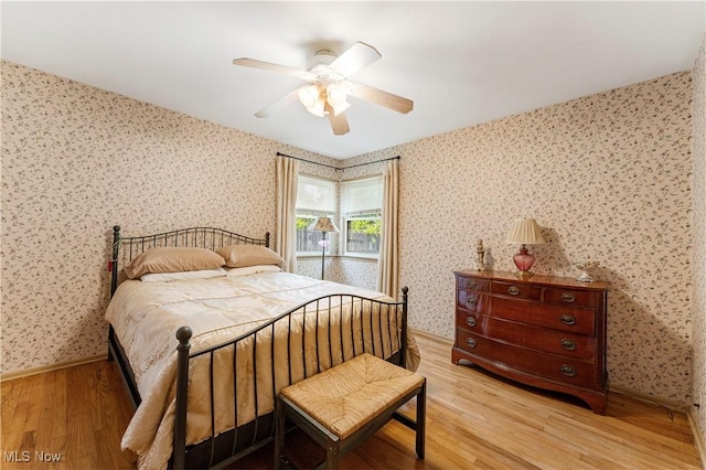 218 Bonnett St SW, North Canton, OH 44720 - bedroom with wallpapered walls, light wood-style flooring, and a ceiling fan