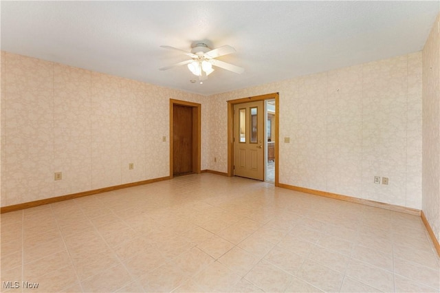 218 Bonnett St SW, North Canton, OH 44720 - spare room featuring a ceiling fan and baseboards