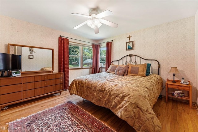 218 Bonnett St SW, North Canton, OH 44720 - bedroom featuring wallpapered walls, wood finished floors, and a ceiling fan