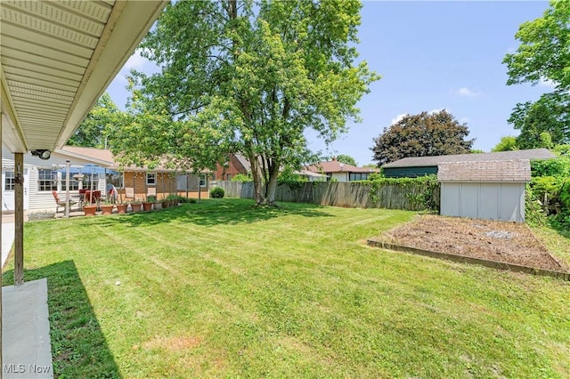 218 Bonnett St SW, North Canton, OH 44720 - fenced backyard featuring a storage shed and a patio area