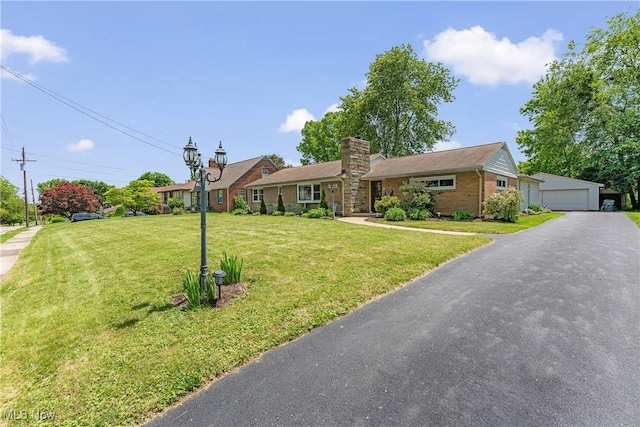 218 Bonnett St SW, North Canton, OH 44720 - ranch-style house with a garage, a front lawn, brick siding, a chimney, and an outbuilding