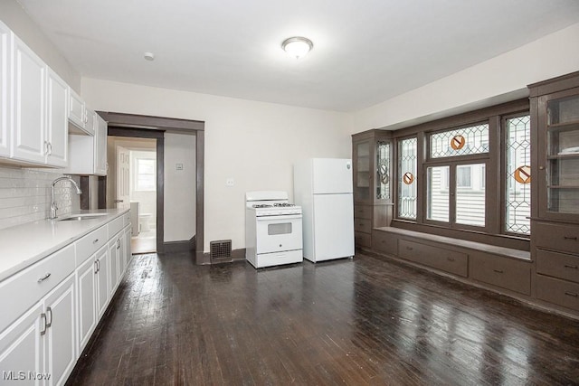 3139 W Blvd, Cleveland, OH 44111 - kitchen featuring white appliances, light countertops, dark wood-type flooring, backsplash, and white cabinetry