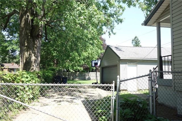 1825 Glenmount Ave, Akron, OH 44301 - view of property exterior featuring a gate, an outbuilding, a shingled roof, and a garage