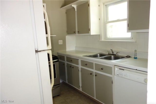1825 Glenmount Ave, Akron, OH 44301 - kitchen featuring white appliances, backsplash, light countertops, and tile patterned flooring