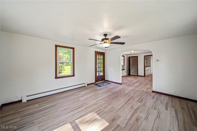 416 N Hambden St, Chardon, OH 44024 - spare room with a baseboard radiator, arched walkways, light wood-style flooring, a ceiling fan, and stairway